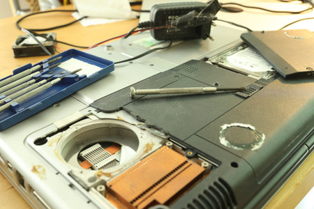 Small screwdriver on a disassembled laptop computer for repair or hardware upgrade.