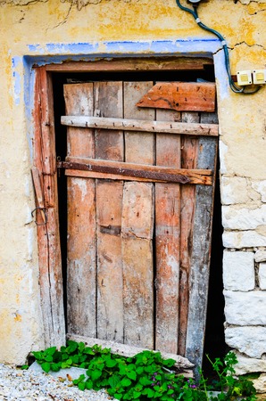 Weathered red door in a village, Ukraine, Europeの写真素材
