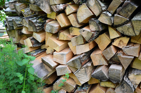 Natural wooden background - closeup of chopped firewood. Firewood stacked and prepared for winter Pile of wood logsの写真素材