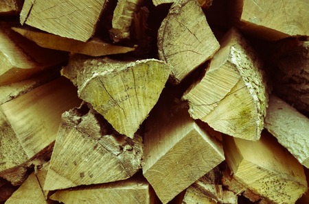 Natural wooden background - closeup of chopped firewood. Firewood stacked and prepared for winter Pile of wood logsの写真素材