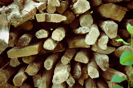 Natural wooden background - closeup of chopped firewood. Firewood stacked and prepared for winter...