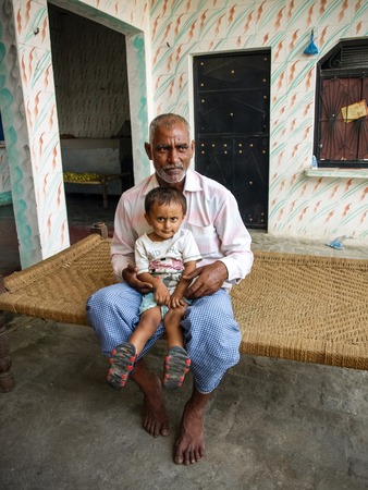 Grandfather with his grandson as they are sitting together, India 2011のeditorial素材