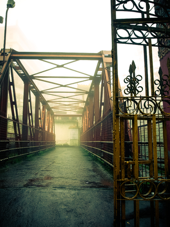 Old railway gold bridge in fog, Indiaの写真素材