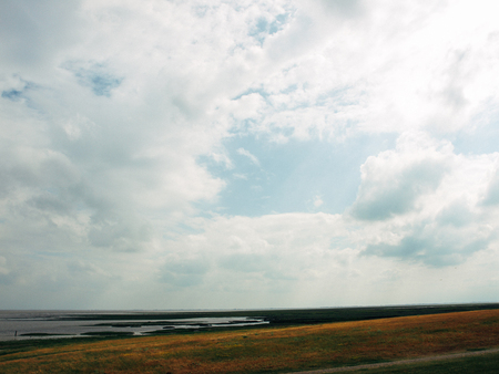 Netherlands beach, calm sea and grey skyの写真素材