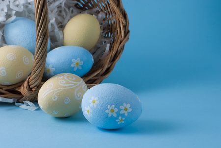 Easter eggs with basket on a blue background