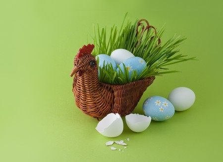 Easter eggs with basket on green backgroundの写真素材