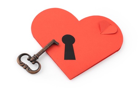 Key and paper heart on white backgroundの写真素材