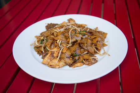 Char kway teow Wok-fried flat rice noodle in spicy sambal paste with chicken and bean sprouts.の写真素材