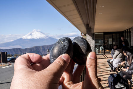 Black eggs cooked in the sulfur of Mount Hakone and sold in Owakudani shops with Mount Fuji in the backgroundのeditorial素材