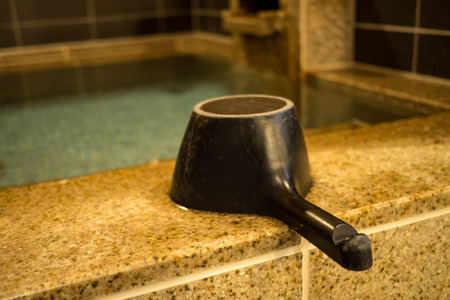 Black wooden onsen bath ladleの写真素材