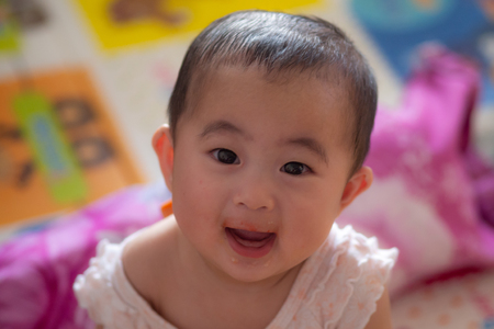 Cute 6 month old baby with strawberriesの写真素材