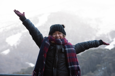 Young woman posing in front of snow covered Mount Kosciuszko at Thredboの写真素材