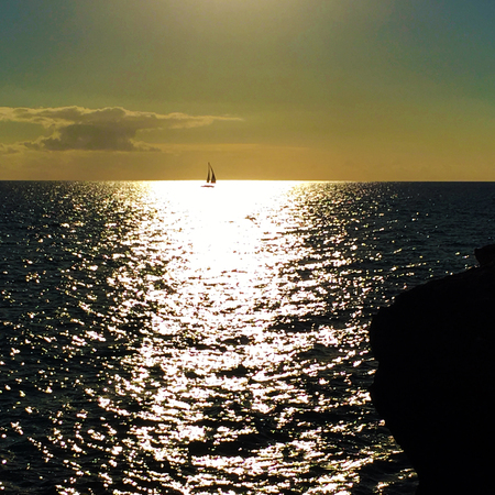 Sailboat in the sunlight on oceanの写真素材