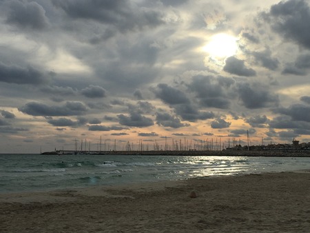Beautiful beach sunset overlooking beach and portの写真素材