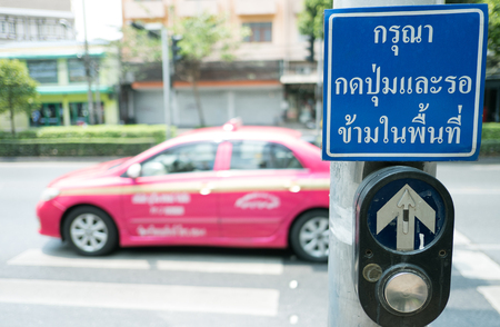 push button for Red traffic light in Thailand. thai language -- (Selective focus)の写真素材