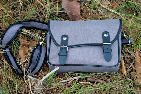 Gray bag on the grass(Selective focus)の写真素材