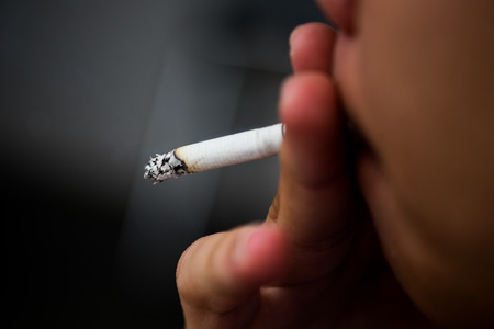 Asia Man smoking cigarette (Selective focus)の写真素材