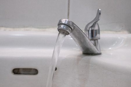 Water running from an open water faucet.