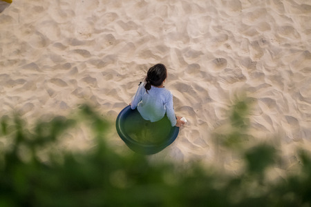 Soft focus Children sitting on sandy.(Selective focus)の写真素材