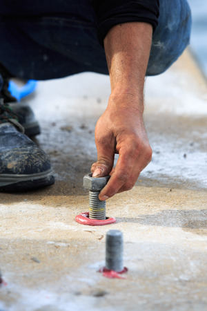 Setting stud bolt into adhesive chemical  anchorの写真素材