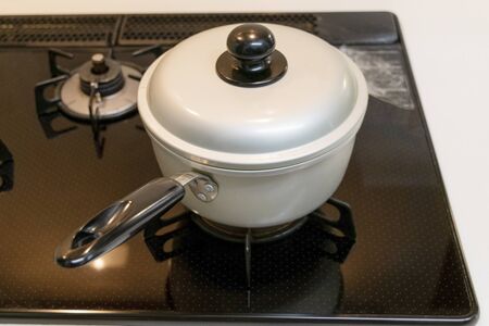 One handed pot on the stoveの写真素材