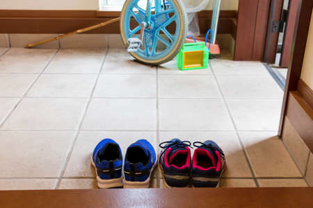 Children's shoes and playthings at the entranceの写真素材
