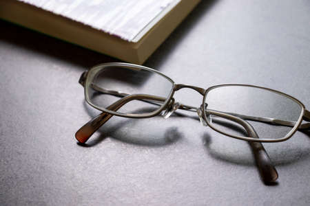 Glasses and books on the tableの写真素材