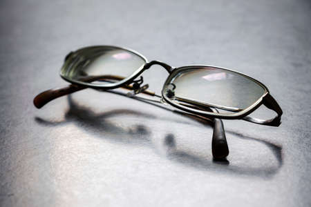 a pair of glasses placed on a tableの写真素材
