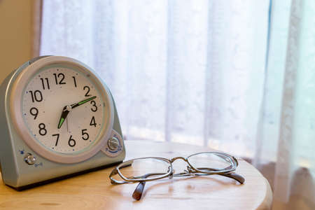 Clock and glasses on the table