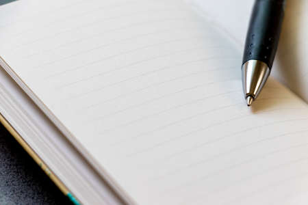 Opened notebook and ballpoint pen nib