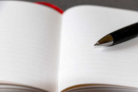 Opened notebook and ballpoint pen nib