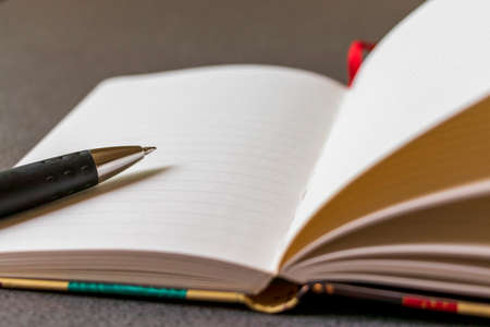 Notebook and ballpoint pen on the tableの写真素材