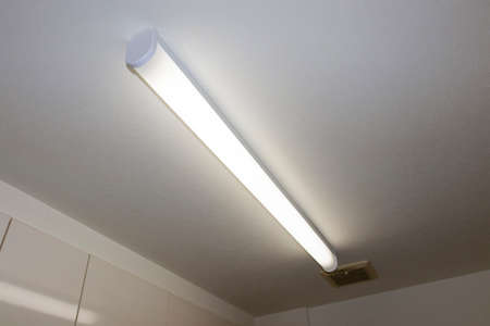 Fluorescent light illuminating the room from the ceiling