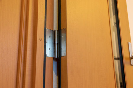 Wooden door and metal hinge
