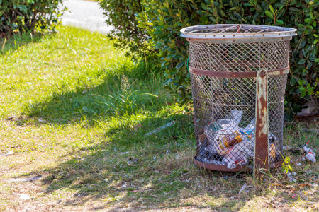 Waste basket made of wire mesh in the parkの写真素材