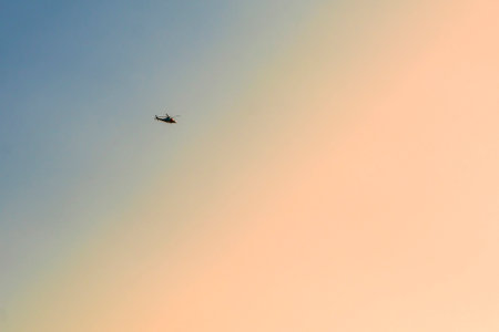 Helicopter flying in the evening sky