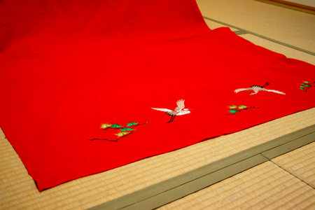 Japanese traditional red felt with the pattern of cranes and pine treesの写真素材