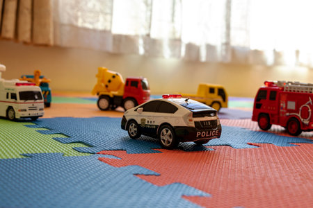 Toy cars on colorful play matsの写真素材