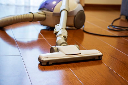 Vacuum cleaner placed on wood flooringの写真素材