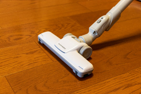 Vacuum cleaner head on wood flooringの写真素材