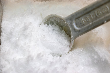 Measure sugar with a measuring spoonの写真素材