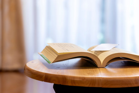 Opened book on wooden table