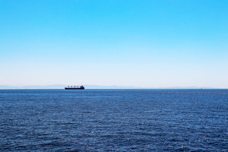 Large ship sailing on the horizonの写真素材