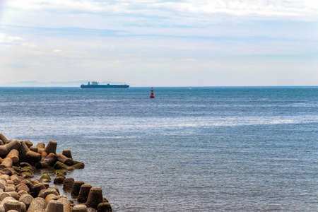 Blue sea seen from river mouthの写真素材