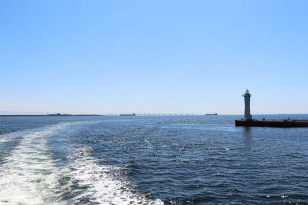 Blue sea with white lighthouseの写真素材