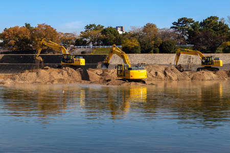 Hydraulic excavators for dredging work in the river