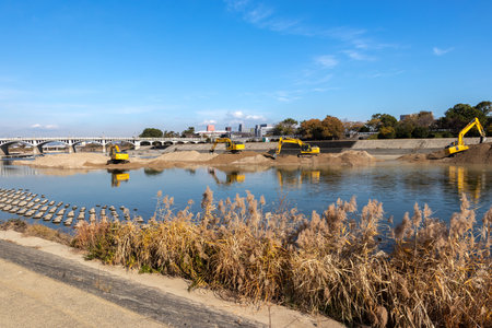 Hydraulic excavators for river conservation work at Muko River, Hyogoの写真素材