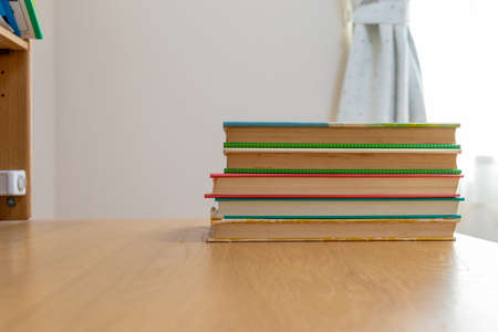 Stacked books on the wooden deskの写真素材