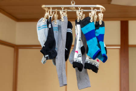 Many socks hung in the room for dryingの写真素材