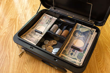 Japanese currency in a portable safeの写真素材